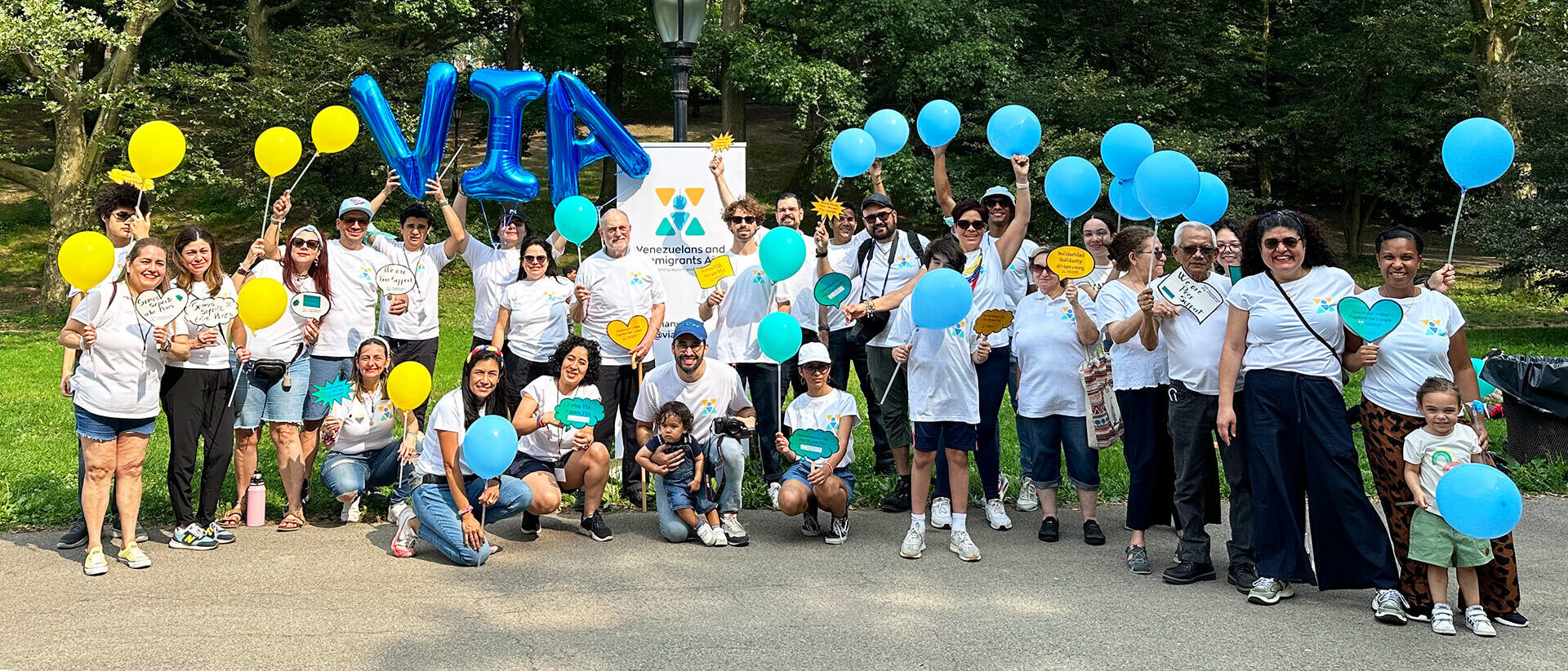 VIA volunteers gathered for a group photo during a community event in the park.