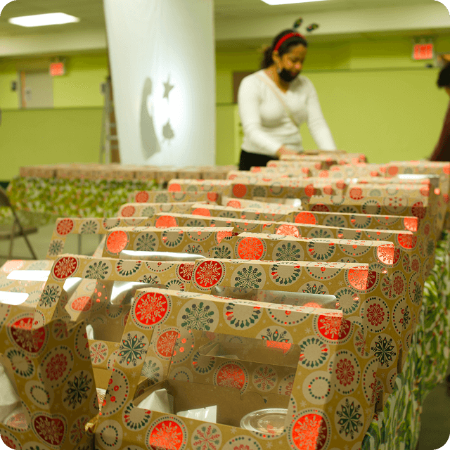 Rows of decorated dinner boxes ready for distribution at VIA’s Traditional Venezuelan Christmas Dinner event.